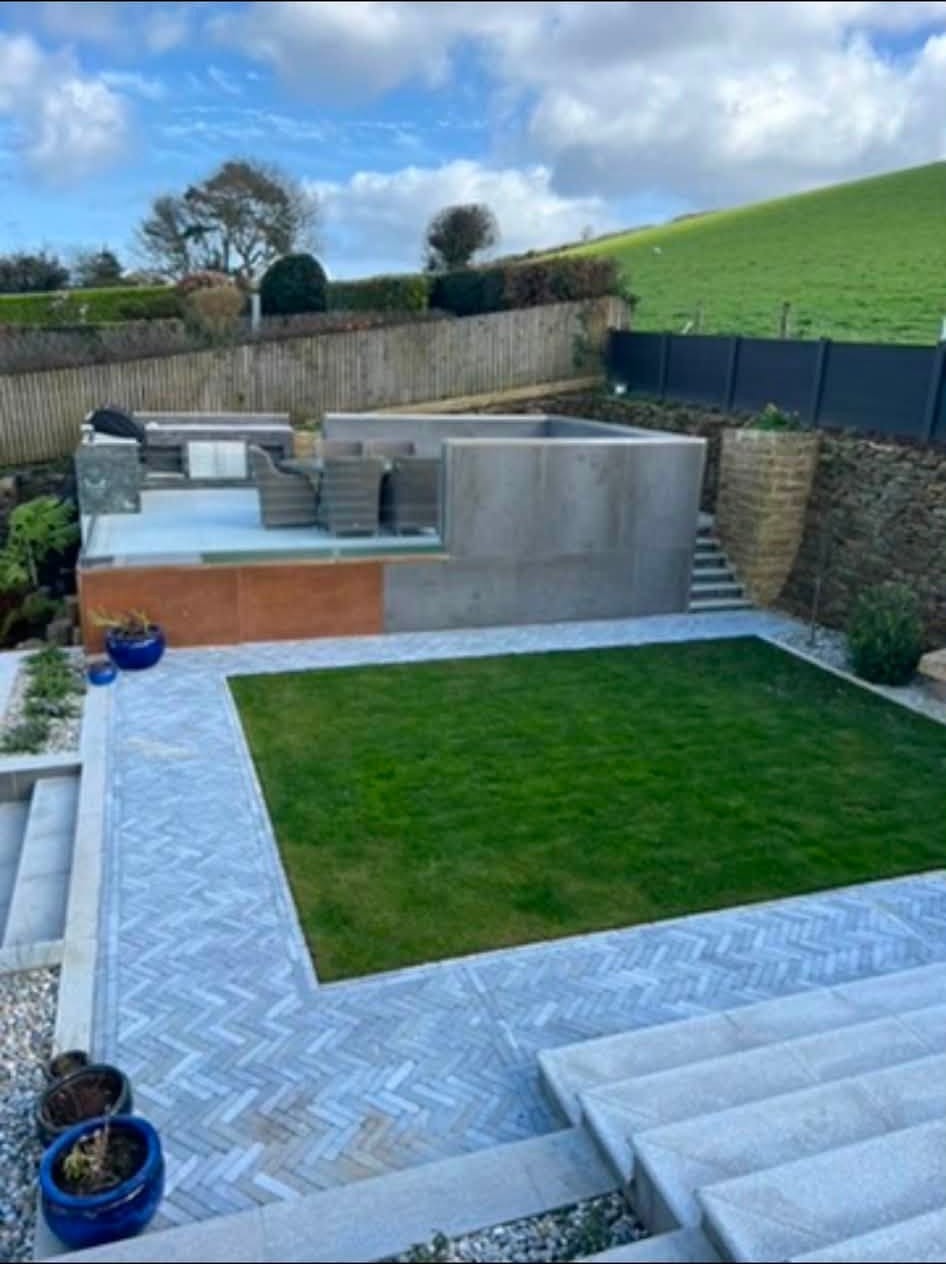 Completed landscaped garden with lawn, paving and raised outdoor area